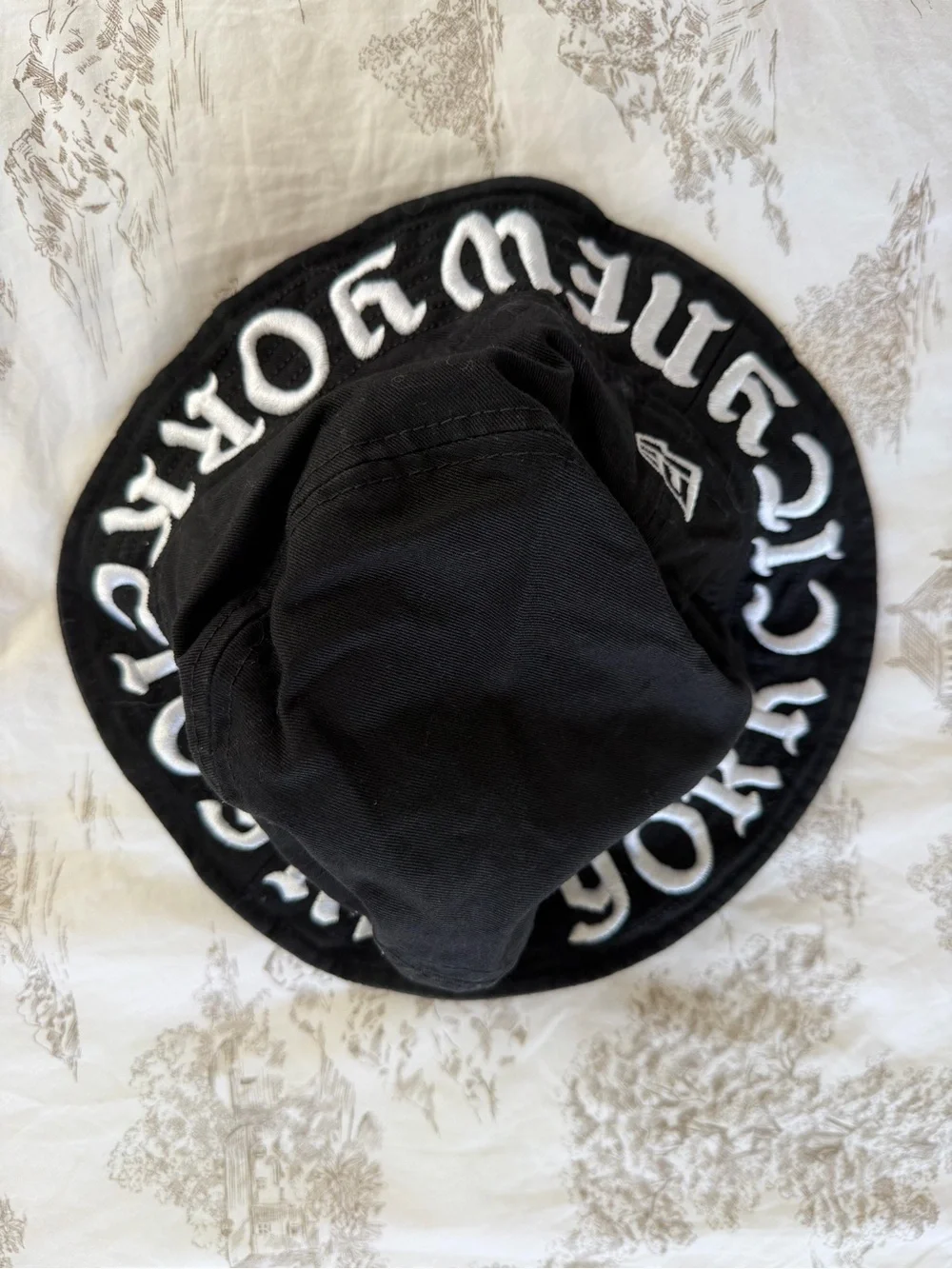New Era Black Bucket Hat with White Embroidered Lettering